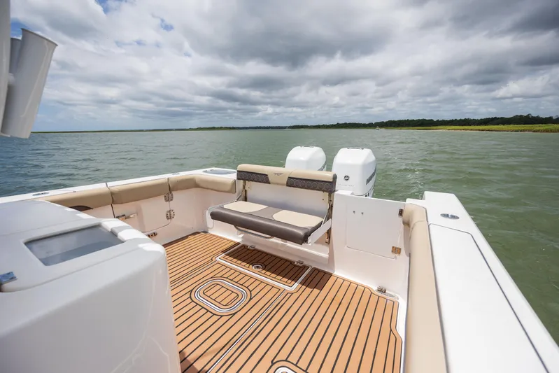  Yacht Photos Pics 2020 Tidewater 320 CC Adventure boat with spacious deck and dual engines on open water.