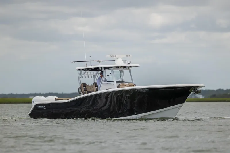  Yacht Photos Pics 2020 Tidewater 320 CC Adventure boat cruising on open water.