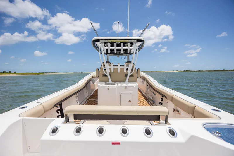  Yacht Photos Pics 2020 Tidewater 320 CC Adventure boat on calm water under blue sky.