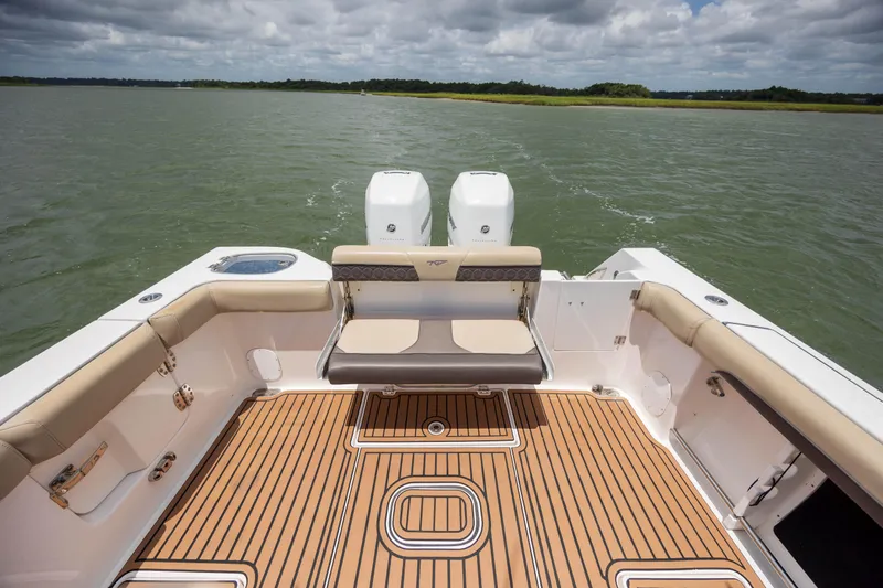  Yacht Photos Pics 2020 Tidewater 320 CC Adventure boat interior with cushioned seating and dual engines.