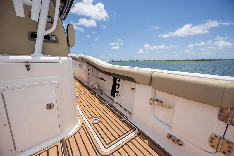  Yacht Photos Pics 2020 Tidewater 320 CC Adventure boat interior with teak flooring, ocean view, and clear sky.