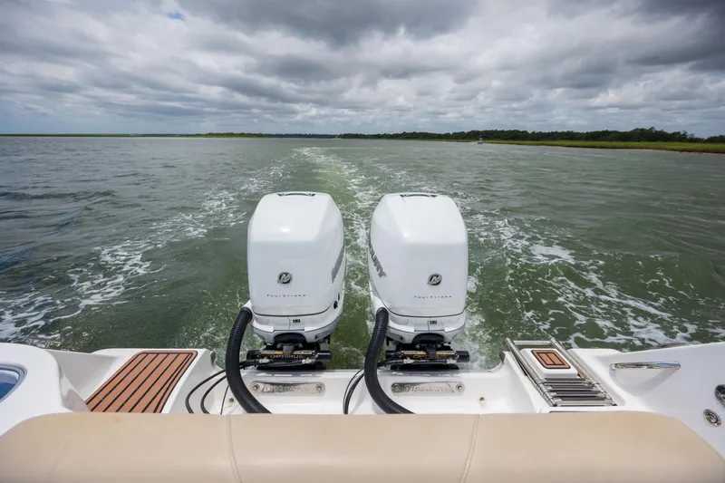  Yacht Photos Pics 2020 Tidewater 320 CC Adventure boat with dual outboard motors on open water.