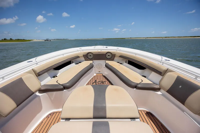  Yacht Photos Pics 2020 Tidewater 320 CC Adventure boat interior with cushioned seating on open water.