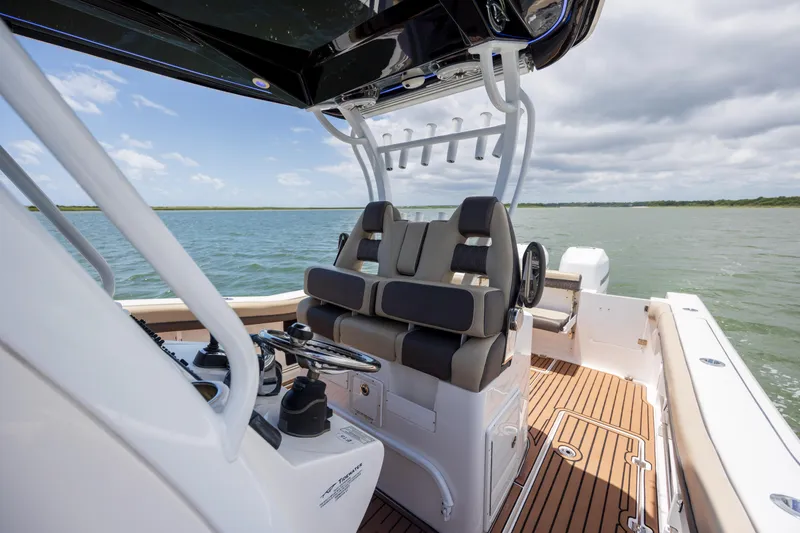 Yacht Photos Pics 2020 Tidewater 320 CC Adventure boat interior with helm and seating on open water.