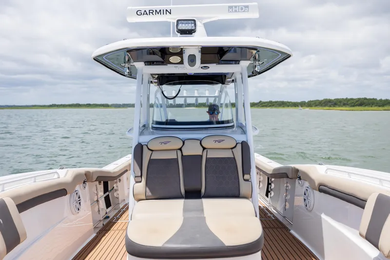 Yacht Photos Pics 2020 Tidewater 320 CC Adventure boat interior with seating, on a calm water body.