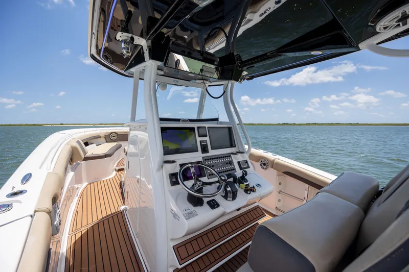  Yacht Photos Pics 2020 Tidewater 320 CC Adventure boat interior with navigation system on open water.