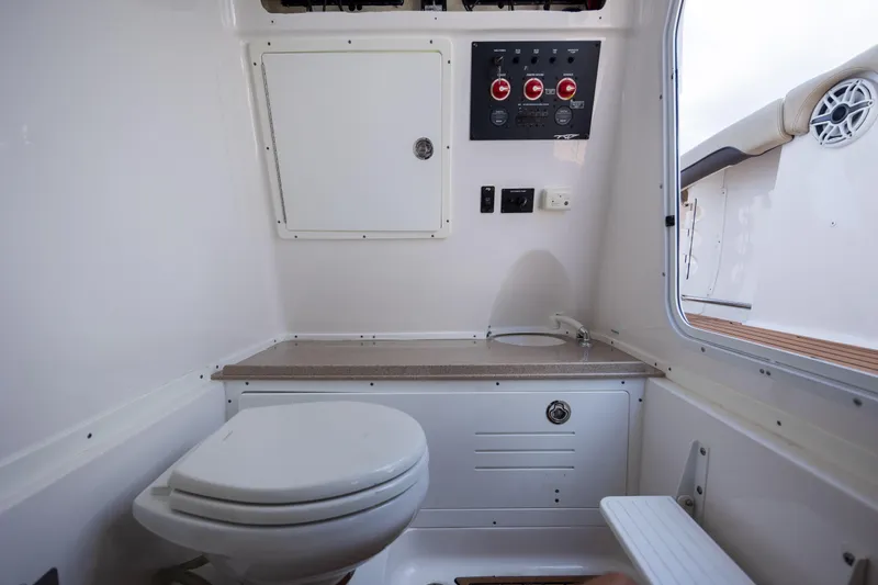  Yacht Photos Pics 2020 Tidewater 320 CC Adventure boat interior with toilet and control panel.