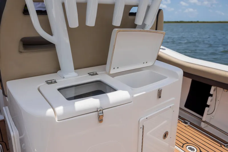  Yacht Photos Pics 2020 Tidewater 320 CC Adventure boat with open storage compartments on deck.