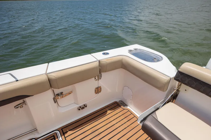  Yacht Photos Pics 2020 Tidewater 320 CC Adventure boat interior with cushioned seating and teak flooring.