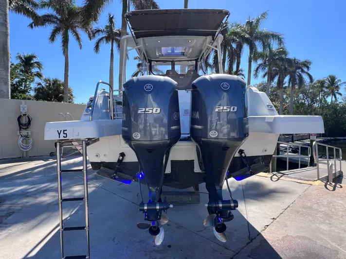  Yacht Photos Pics 2021 Jeanneau Leader 9.0 WA with twin Yamaha 250 engines, docked under palm trees.