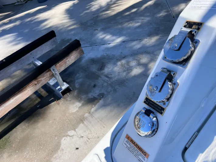  Yacht Photos Pics 2021 Jeanneau Leader 9.0 WA boat controls with warning label, dockside view.