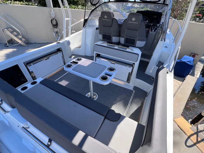  Yacht Photos Pics 2021 Jeanneau Leader 9.0 WA boat interior with seating and table setup.