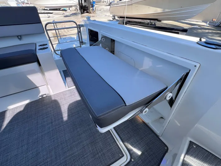  Yacht Photos Pics 2021 Jeanneau Leader 9.0 WA boat interior with foldable seat and modern design.