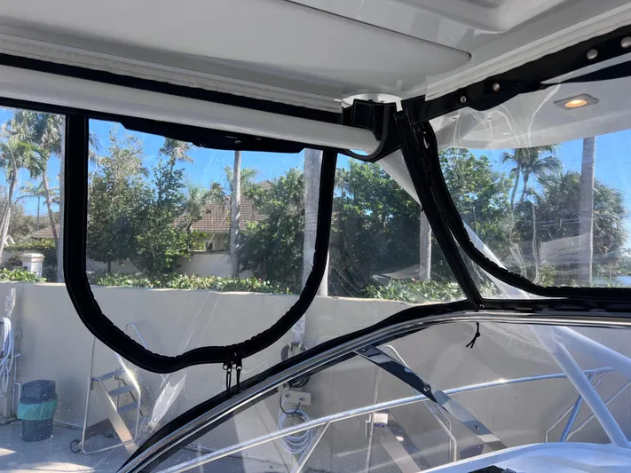  Yacht Photos Pics 2021 Jeanneau Leader 9.0 WA boat interior with clear enclosure and scenic outdoor view.