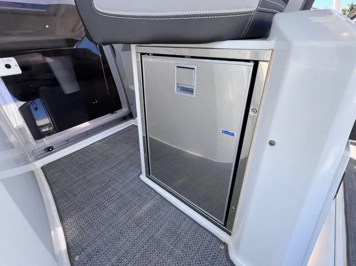  Yacht Photos Pics 2021 Jeanneau Leader 9.0 WA interior with compact stainless steel fridge.