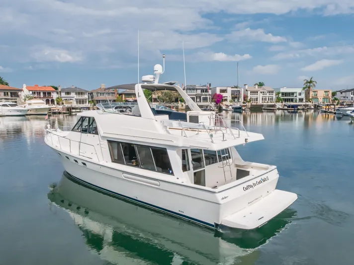 Coffey To Cocktails II Yacht Photos Pics 1998 Bayliner 4788 Pilot House Motoryacht docked in a scenic marina.