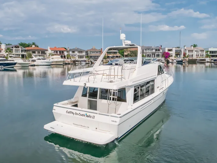 Coffey To Cocktails II Yacht Photos Pics 1998 Bayliner 4788 Pilot House Motoryacht in a serene marina setting.