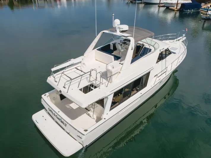 Coffey To Cocktails II Yacht Photos Pics 1998 Bayliner 4788 Pilot House Motoryacht on calm water, aerial view.