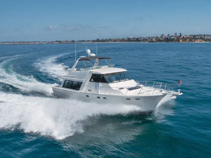 Coffey To Cocktails II Yacht Photos Pics 1998 Bayliner 4788 Pilot House Motoryacht cruising on open water.