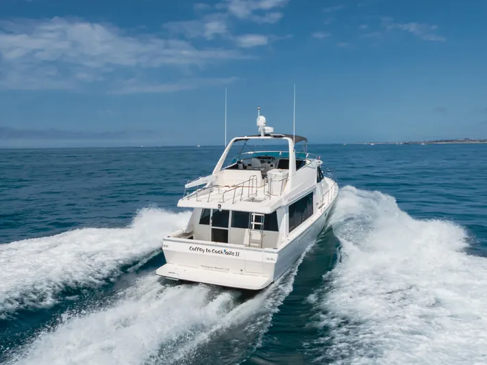 Coffey To Cocktails II Yacht Photos Pics 1998 Bayliner 4788 Pilot House Motoryacht cruising on open water under clear skies.