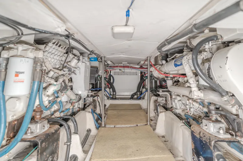 Coffey To Cocktails II Yacht Photos Pics Engine room of 1998 Bayliner 4788 Pilot House Motoryacht, showcasing mechanical components and piping.