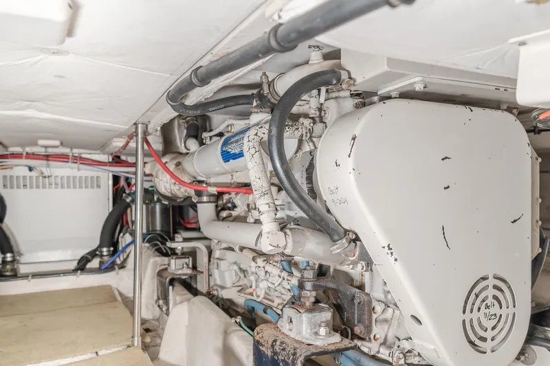 Coffey To Cocktails II Yacht Photos Pics Engine room of 1998 Bayliner 4788 Pilot House Motoryacht, showcasing mechanical components and wiring.