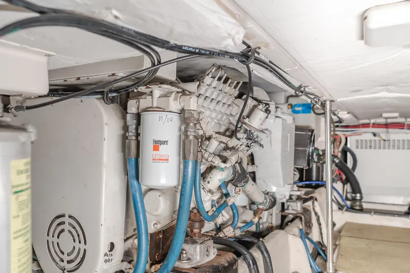 Coffey To Cocktails II Yacht Photos Pics Engine room of 1998 Bayliner 4788 Pilot House Motoryacht with visible components and wiring.