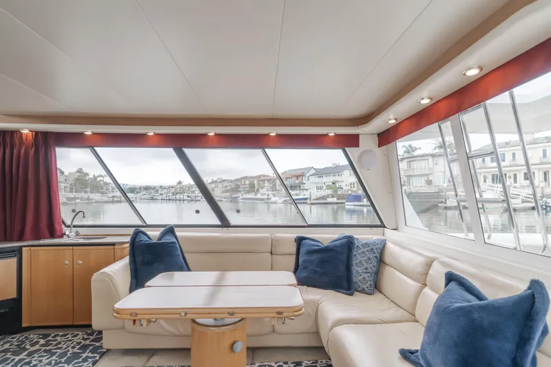 Coffey To Cocktails II Yacht Photos Pics Luxurious interior of 1998 Bayliner 4788 Pilot House Motoryacht with waterfront view.