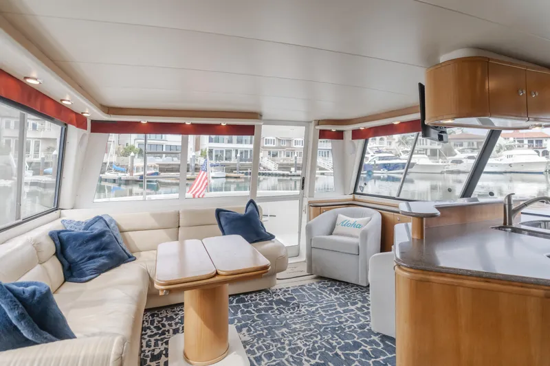 Coffey To Cocktails II Yacht Photos Pics Luxurious interior of 1998 Bayliner 4788 Pilot House Motoryacht with marina view.