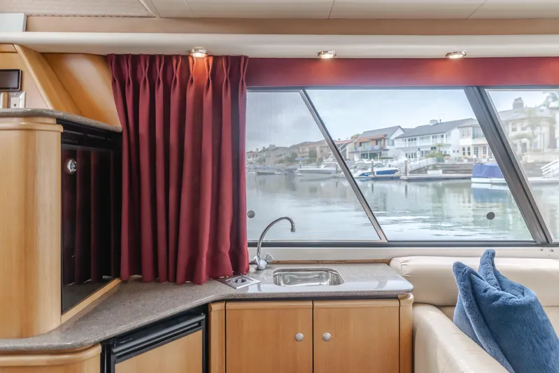 Coffey To Cocktails II Yacht Photos Pics Interior of 1998 Bayliner 4788 Pilot House Motoryacht with window view and kitchenette.