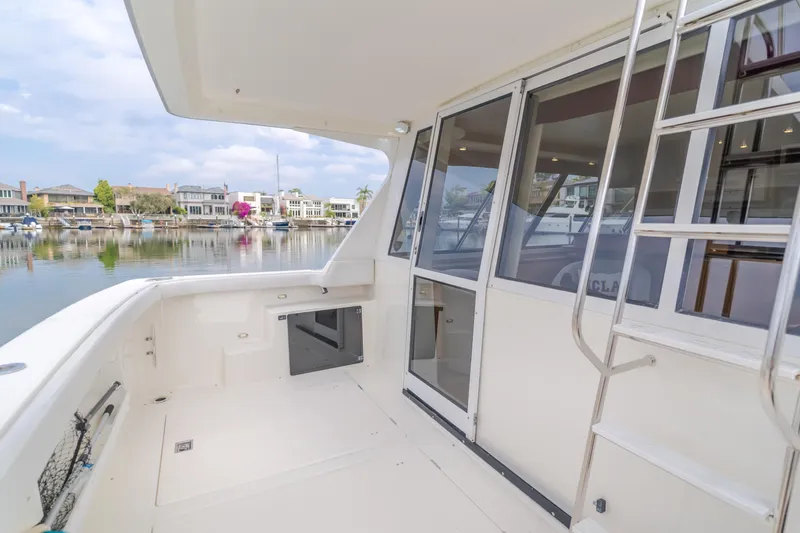 Coffey To Cocktails II Yacht Photos Pics 1998 Bayliner 4788 Pilot House Motoryacht deck with marina view and ladder access.