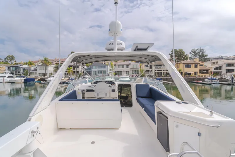 Coffey To Cocktails II Yacht Photos Pics 1998 Bayliner 4788 Pilot House Motoryacht docked in a scenic marina.