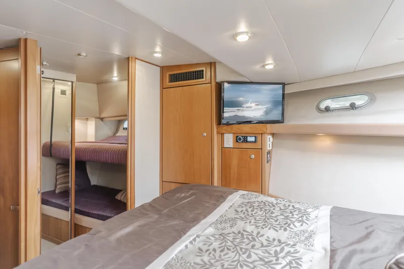 Coffey To Cocktails II Yacht Photos Pics Luxurious interior of 1998 Bayliner 4788 Pilot House Motoryacht with cozy bedding and modern amenities.