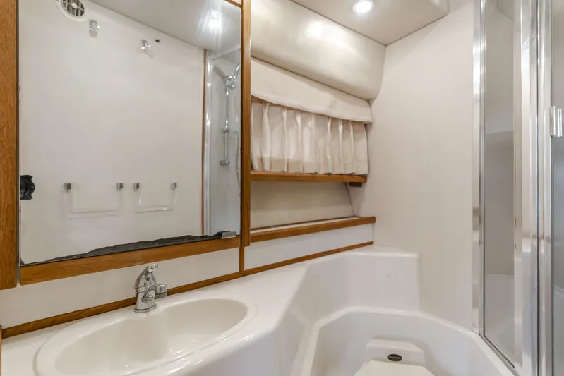 Coffey To Cocktails II Yacht Photos Pics Bathroom interior of 1998 Bayliner 4788 Pilot House Motoryacht with sink and shower.
