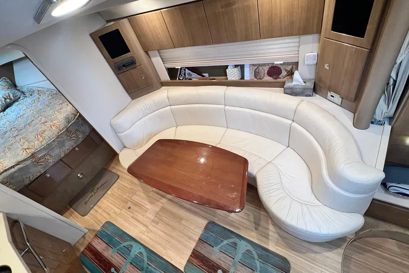No Worries Yacht Photos Pics 2011 Formula 37 Performance Cruiser interior with curved seating and wooden table.