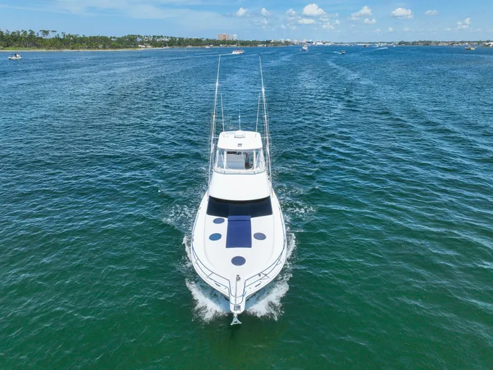 The Callback Yacht Photos Pics 2007 Riviera 42 Flybridge yacht cruising on open water under a clear blue sky.
