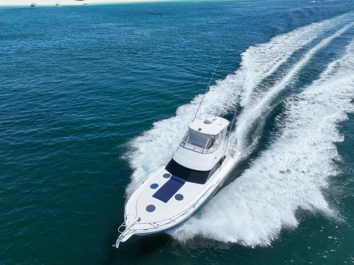 The Callback Yacht Photos Pics 2007 Riviera 42 Flybridge yacht cruising on open blue water.