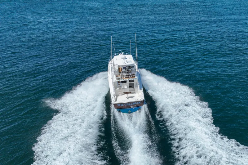 The Callback Yacht Photos Pics 2007 Riviera 42 Flybridge yacht cruising on open water, creating a wake.