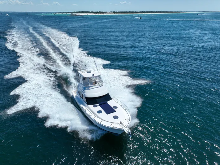 The Callback Yacht Photos Pics 2007 Riviera 42 Flybridge yacht cruising on open blue ocean waters.