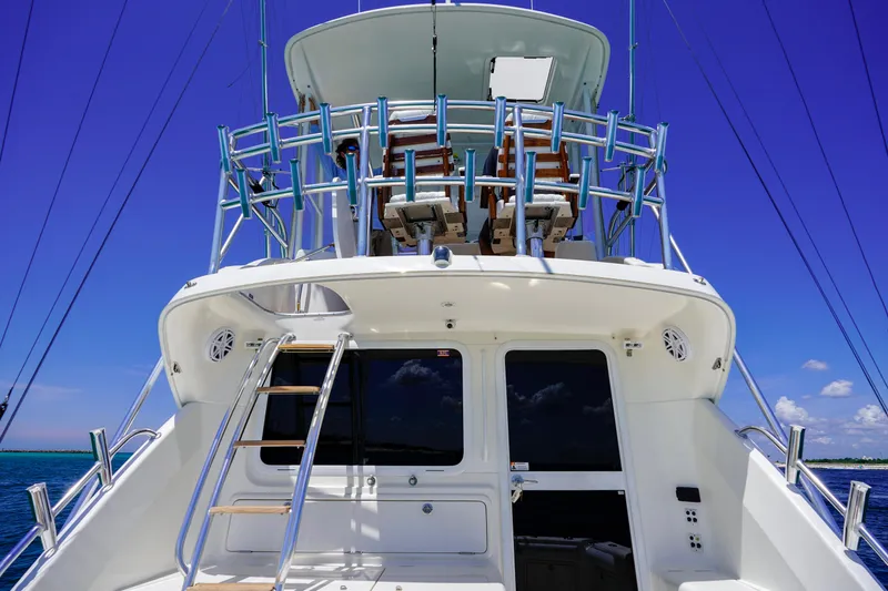 The Callback Yacht Photos Pics 2007 Riviera 42 Flybridge yacht with ladder and blue sky background.