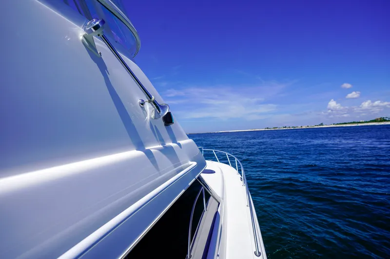 The Callback Yacht Photos Pics 2007 Riviera 42 Flybridge yacht cruising on a clear blue ocean.