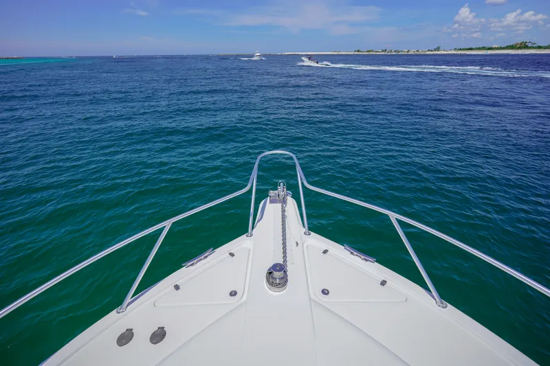 The Callback Yacht Photos Pics Bow view of 2007 Riviera 42 Flybridge yacht cruising on open sea.