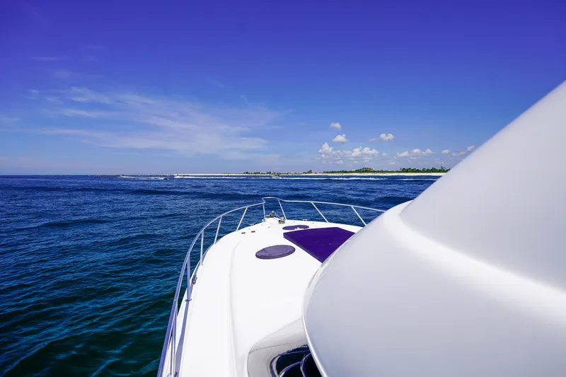 The Callback Yacht Photos Pics 2007 Riviera 42 Flybridge yacht cruising on open blue sea under clear sky.