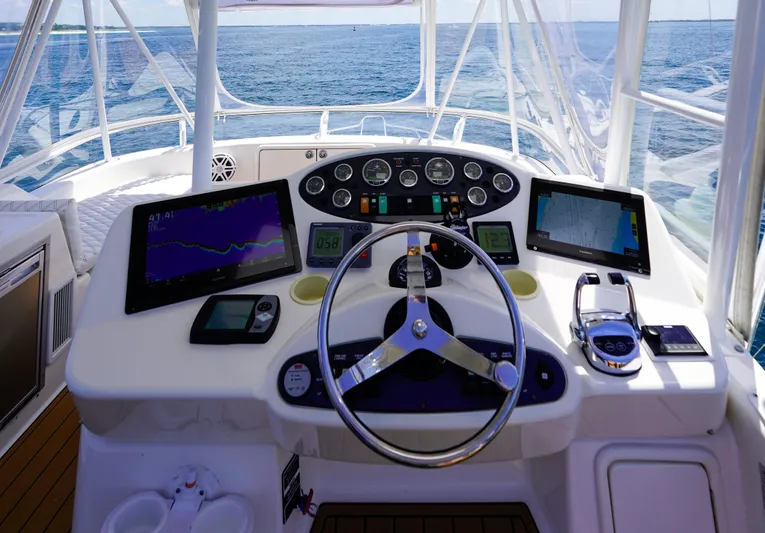 The Callback Yacht Photos Pics Helm of 2007 Riviera 42 Flybridge yacht with navigation screens and controls.