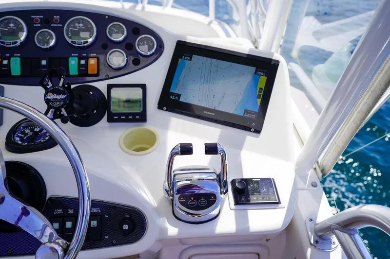 The Callback Yacht Photos Pics Control panel of 2007 Riviera 42 Flybridge with navigation screen and steering wheel.