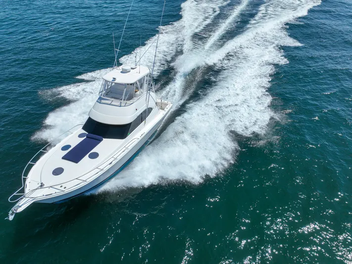 The Callback Yacht Photos Pics 2007 Riviera 42 Flybridge yacht cruising on open water, creating a wake.