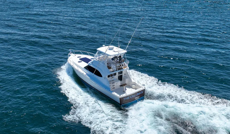 The Callback Yacht Photos Pics 2007 Riviera 42 Flybridge cruising on open water, creating a wake behind.