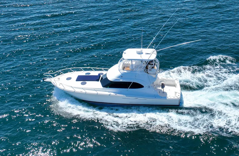 The Callback Yacht Photos Pics 2007 Riviera 42 Flybridge yacht cruising on open blue waters.