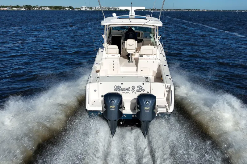 Meant To Be Yacht Photos Pics 2018 Grady-White Express 330 boat cruising on open water, rear view.