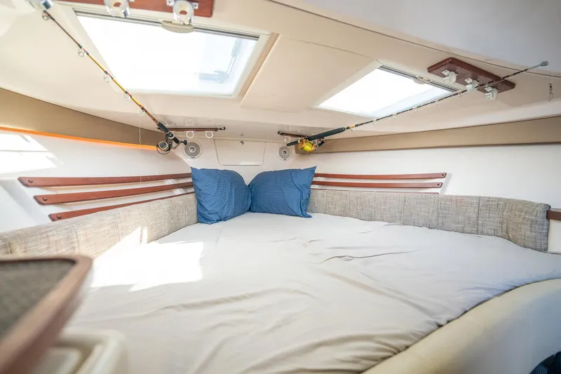 Meant To Be Yacht Photos Pics 2018 Grady-White Express 330 cabin interior with bed, skylights, and fishing rods.